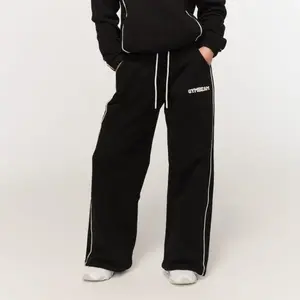GymBeam Dámské tepláky Varsity Black - XS obraz
