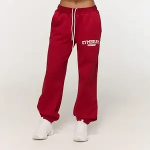 GymBeam Dámské tepláky Varsity Red - L obraz